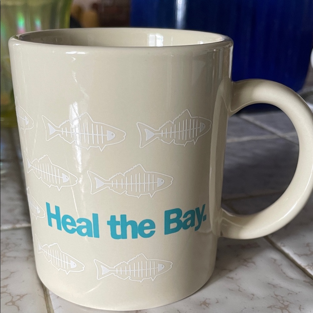 Heal the Bay Cream Mug with Blue Text